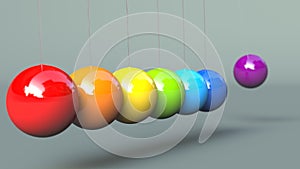 Colerful Newton`s Cradle isolated on grey background photo