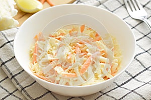 Coleslaw salad with carrot and cabbage. Healthy food concept.