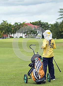 Colf caddie on the fairway