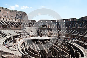 The Coliseum on the inside, Roman architecture with stones. Ancient and historical monument in Europe. On a sunny day with blue sk