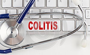 COLITIS text on keyboard with stethoscope , medical concept