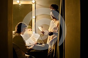 Collaborating on Theater Script in Dressing Room