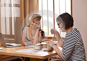 Collaboration, phone call and writing with business women in office together for planning or strategy. Laptop