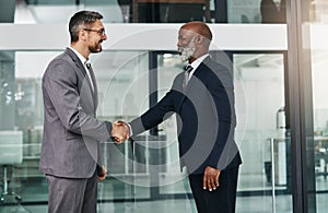 This collaboration will take the business world by storm. two businessmen shaking hands in an modern office.