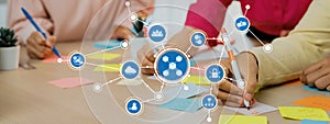 Collaborative brainstorming session with sticky notes and digital networking concepts, showcasing teamwork and
