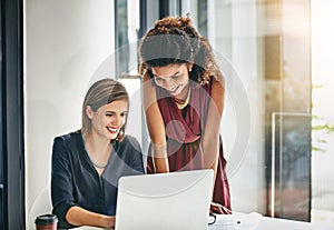 Collaborative contributions makes for efficient business dealings. two businesswomen working together on a laptop in an