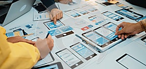 Collaborative Team Meeting for Mobile App Development with Wireframes, Prototypes, and Brainstorming in a Creative