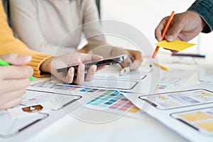 Collaborative UX UI Design Process with Team Working on Mobile App Prototypes and Wireframes