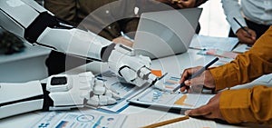 Collaborative Workspace with Robot and Humans Analyzing Data on Tablet and Laptop in a Modern Office Setting. Noogenesis