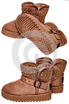 Collage boots for children. Close-up of a pair of elegant brown suede winter boots which are lined with fur. Girls winter shoe