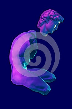 Collage with David face and sculpture of male nude torso in color neon light. Ancient statue in modern creative concept