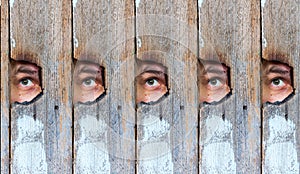 Collage of the human eye, voyeur spying through a hole in the old wooden fence