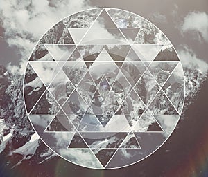 Collage with the mountains landscape and the sacred geometry symbol shri yantra photo
