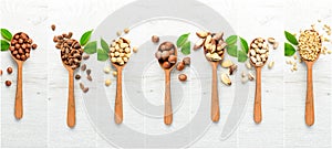 Collage. Nuts in a wooden spoon.