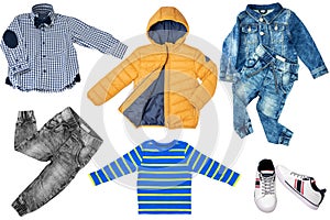 Collage set of little boys autumn clothes isolated on a white background. Denim trousers and jacket, sneaker, a down jacket, pants