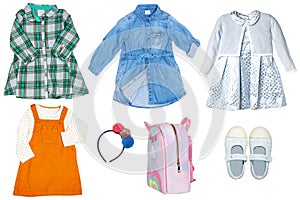 Collage set of little girls summer clothes isolated on a white background. The collection of stylish dresses, a denim dress, shoes