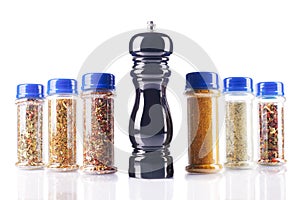 Different spices jars and pepper mill