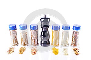 Different spices jars and pepper mill