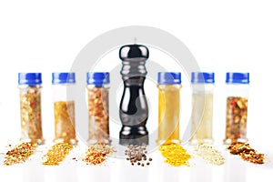 Different spices jars and pepper mill