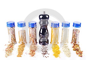 Different spices jars and pepper mill