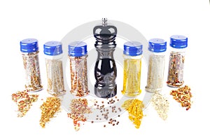 Different spices jars and pepper mill