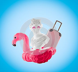 Collage of statue head, inflatable flamingo, pink glasses and suitcase on  blue background. Summer travel poster concept