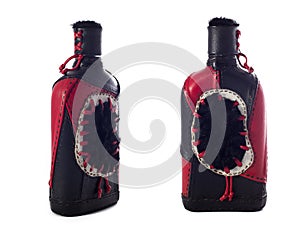 Collage of two shots of leather decorative bottle or flask for alcohol drinks on white