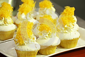 Collage of various cupcakes: vanilla in decorative cup
