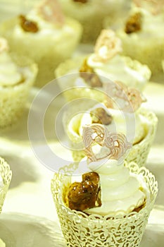 Collage of various cupcakes: vanilla in decorative cup