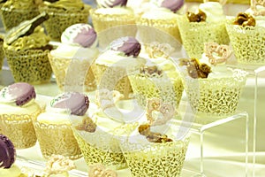 Collage of various cupcakes: vanilla in decorative cup