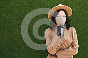 Collage of woman wearing different medical face masks on green background. Virus protection with masks of various fashion styles