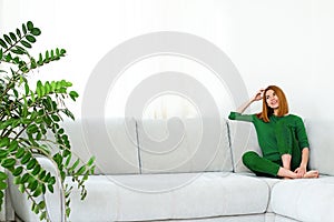 Collage young beautiful red haired girl in green clothes at home with house plants in a different mood and a variety of emotions.