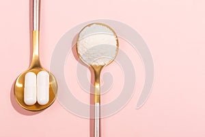 Collagen powder and pills on pink background photo