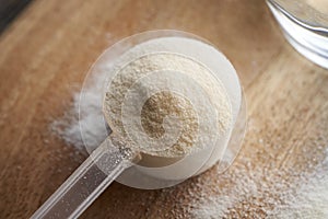 Collagen powder in a plastic measuring spoon