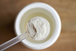 Collagen powder in a plastic measuring spoon