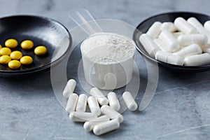 Collagen powder, Proline and MSM Sulfur capsules and Vitamin C tablets.