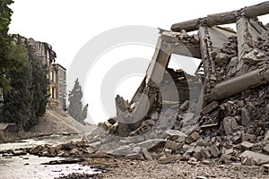 Collapsed concrete industrial building isolated on white. Disaster scene full of debris, dust and damaged house