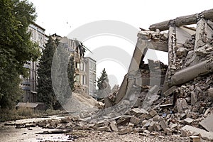 Collapsed concrete industrial building isolated on white. Disaster scene full of debris, dust and damaged house