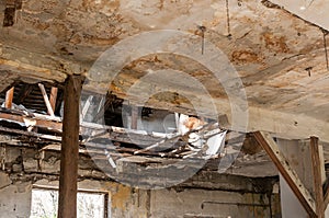 Collapsed roof of the total damaged domestic house indoor from natural disaster or catastrophe