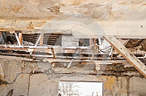 Collapsed roof of the total damaged domestic house indoor from natural disaster or catastrophe