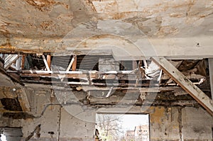 Collapsed roof of the total damaged domestic house indoor from natural disaster or catastrophe