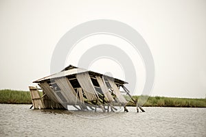 Collapsed stilt house photo