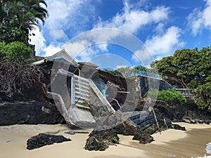 Collapsed to the beach below ocean front home seawall. Shoreline damaged by coastal erosion during tropical storm