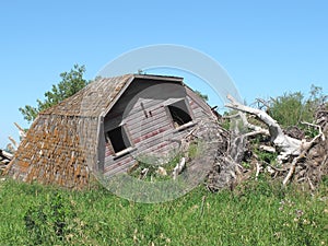 Collapsed wooden farm barn isolated photo