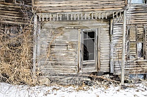Collapsing porch on abandoned farmhouse