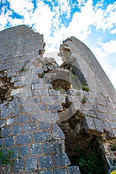 Collapsing tower of fortress Kosmac against a blue cloudy sky. Ancient Austro-Hungarian fortress.  Montenego