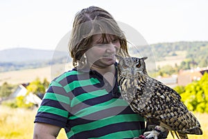 Collared Scops Owl sitting on the hand of animal keeper