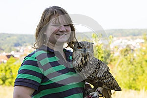 Collared Scops Owl sitting on the hand of animal keeper