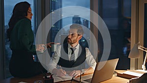 Colleague bringing tea man executive manager working at office desk late evening