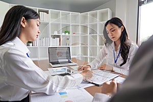 Colleague discuss business brainstorming and price charts analyze business people at the desk in collaboration office